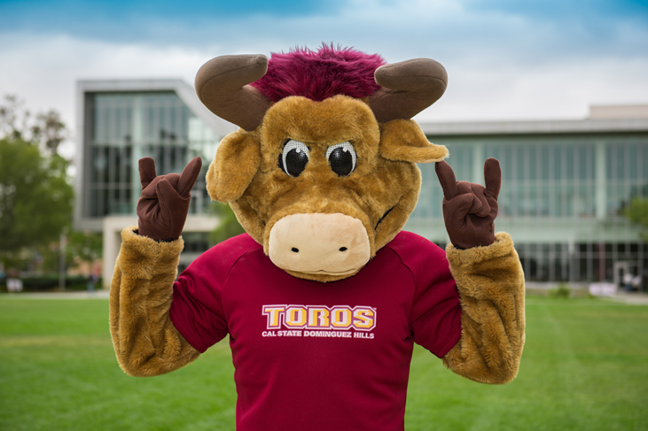 photography sample - Teddy the Toro mascot make the toro hand sign outside Loker Student Union