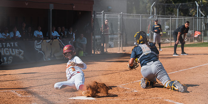 Baseball player sliding home