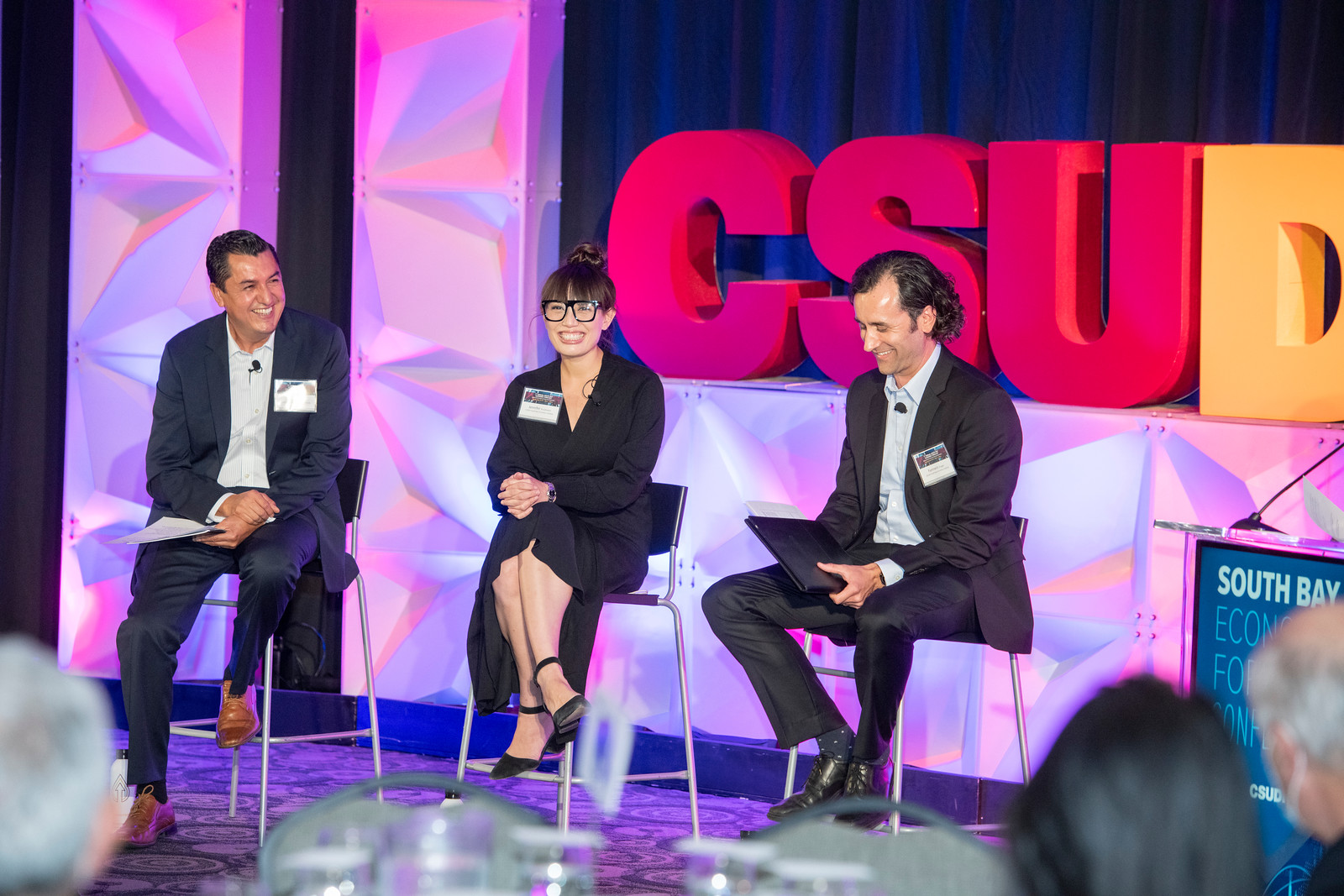 business faculty sitting on stage