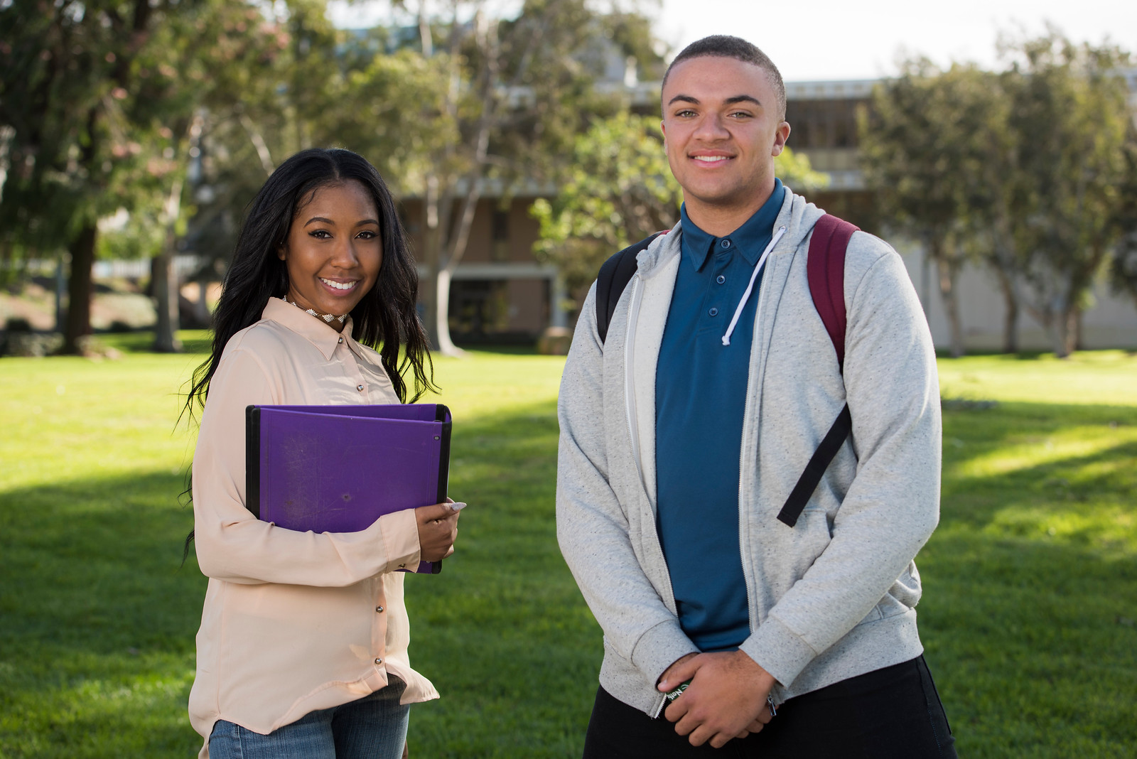 Students standing by the grass