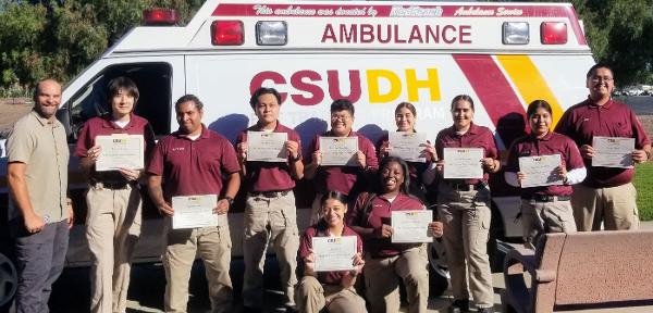 CSUDH EMT Instructor Jess Nalley (left) with Summer 2022 Cohort Graduates