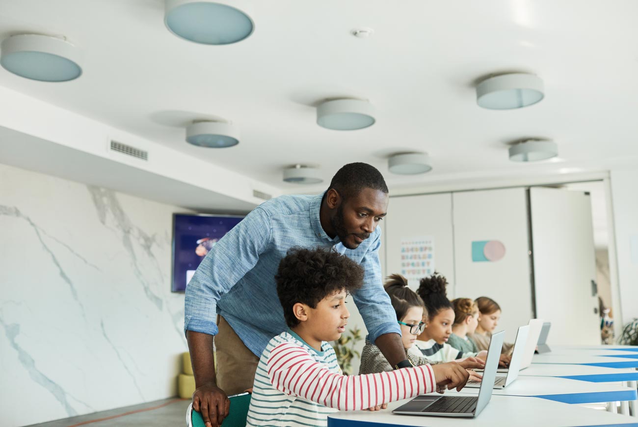 Educator helping student with technology