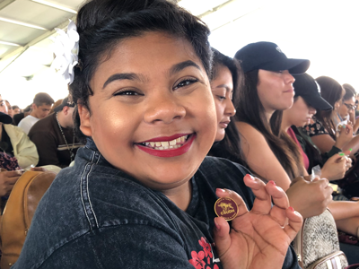 Student showing off her CSUDH Toro pin