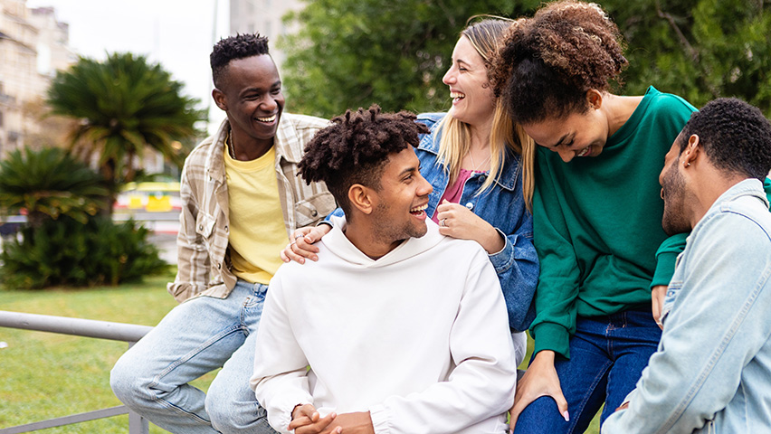 Happy multiethnic group of friends having fun outdoors