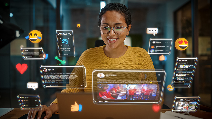 Woman working on computer, social media icons, augmented reality, connectivity.
