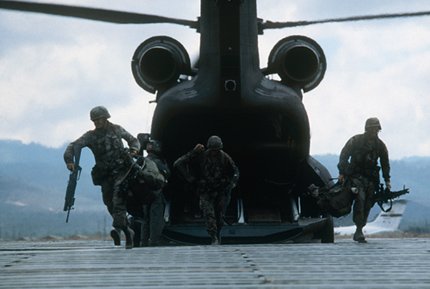 Military men stepping out of a helicopter