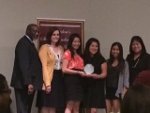 students Pi Theta Epsilon holding a trophy