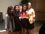 4 ladies from Pi Theta Epsilon holding trophy