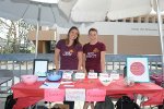 two students with MSOT shirt at booth