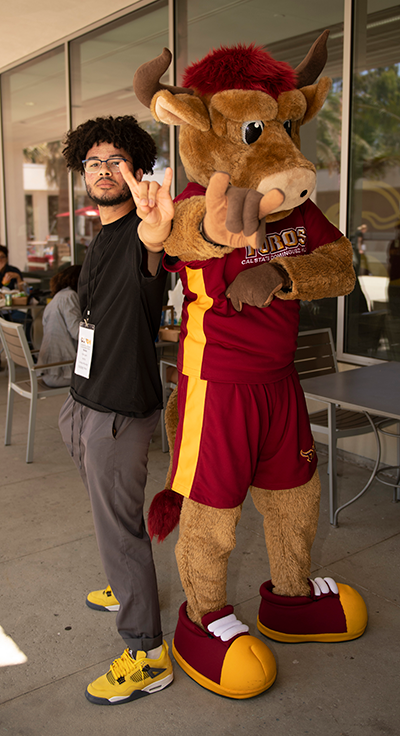 Student standing with Teddy Toro Student standing with Teddy Toro