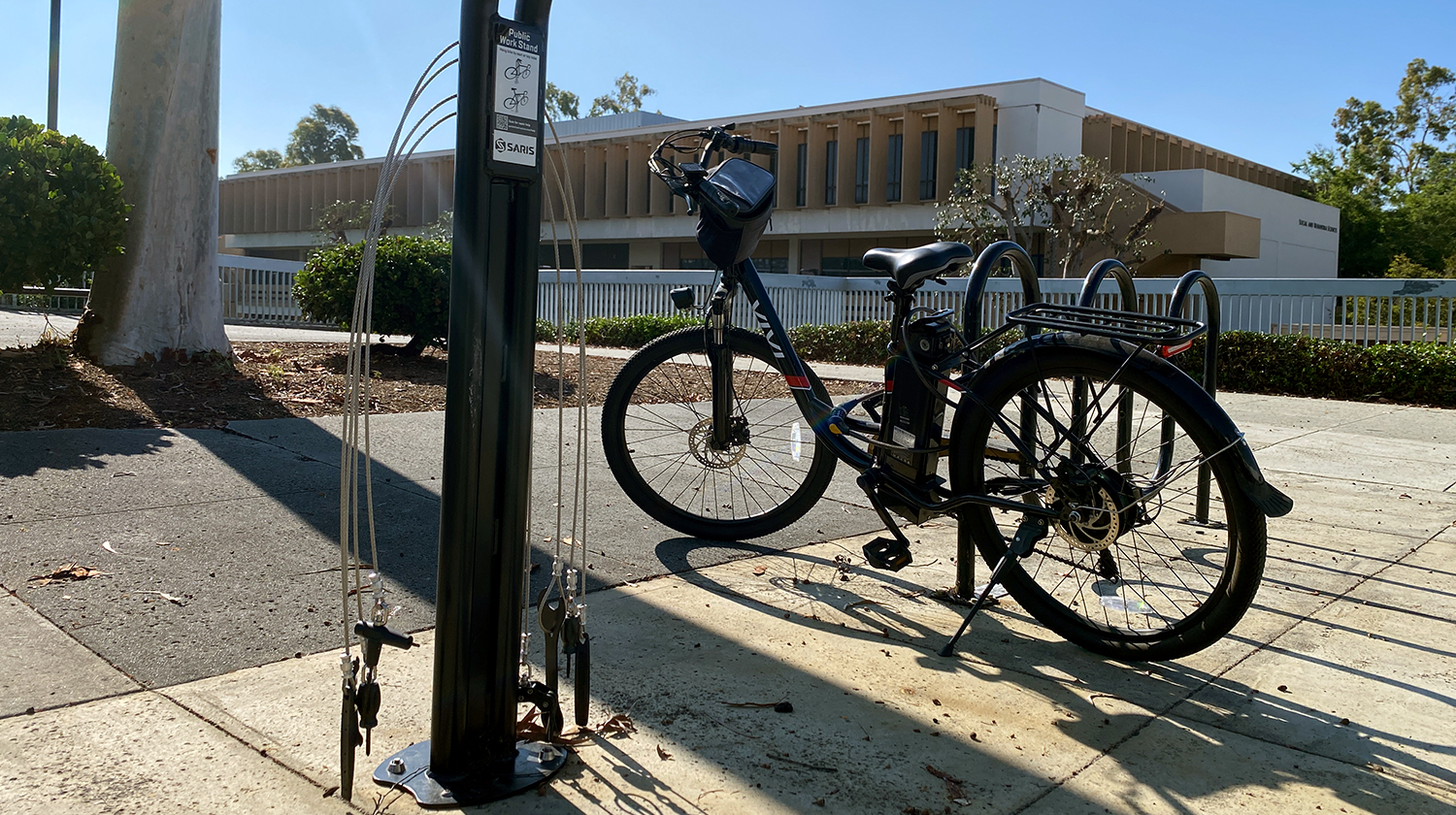 Bike repair station with bike parked in background